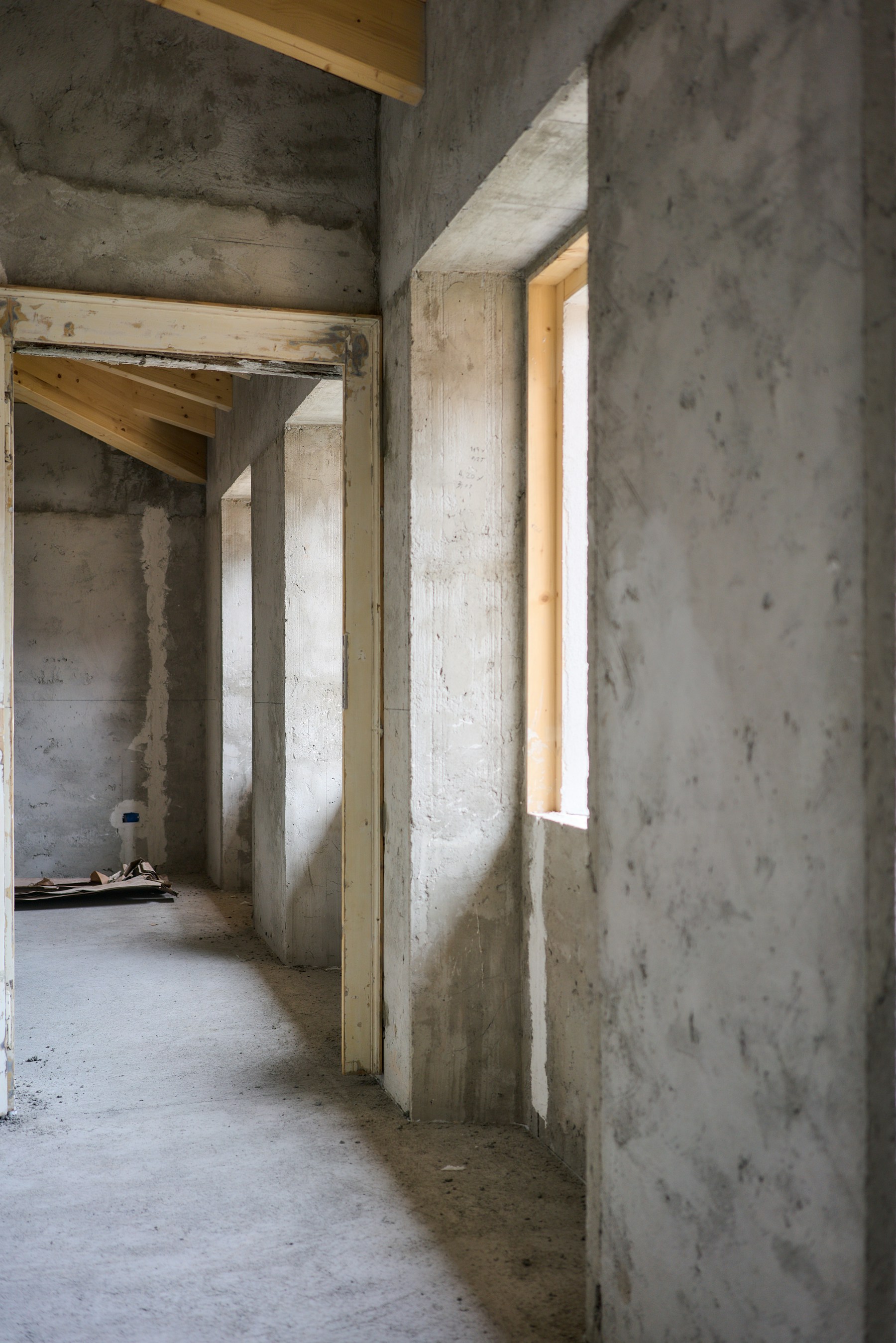 An unfinished concrete interior during construction